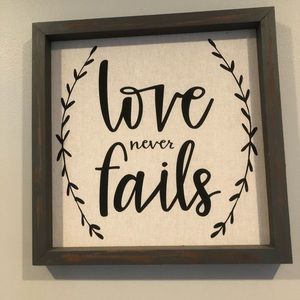 “Love never fails” decor sign